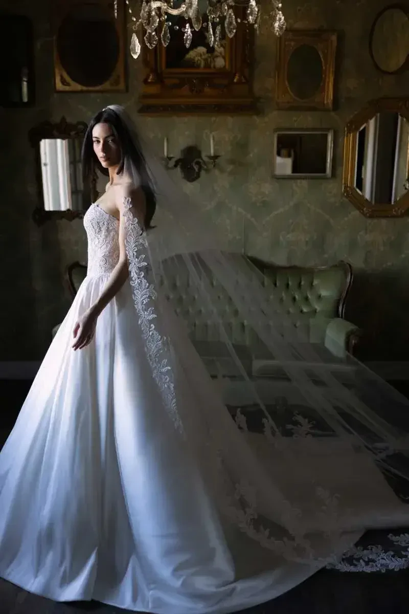 model is wearing a bold ball gown wedding dress