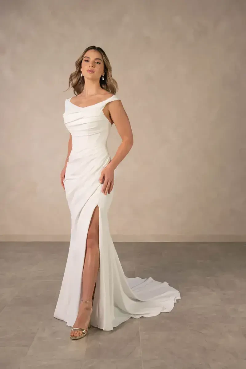 model is wearing an off the shoulder bridal gown